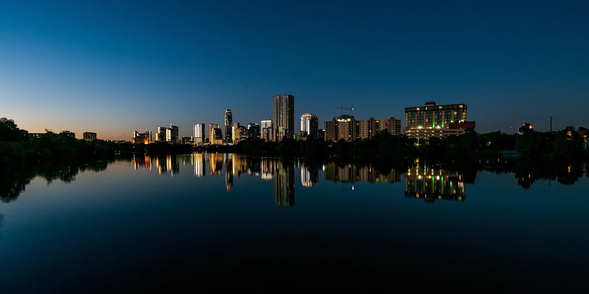 Austin skyline reflected in Lady Bird Lake at dusk