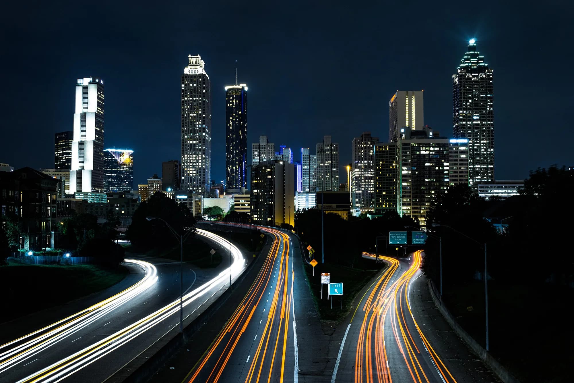 Atlanta skyline at night from the Jackson Street Bridge with traffic light trails