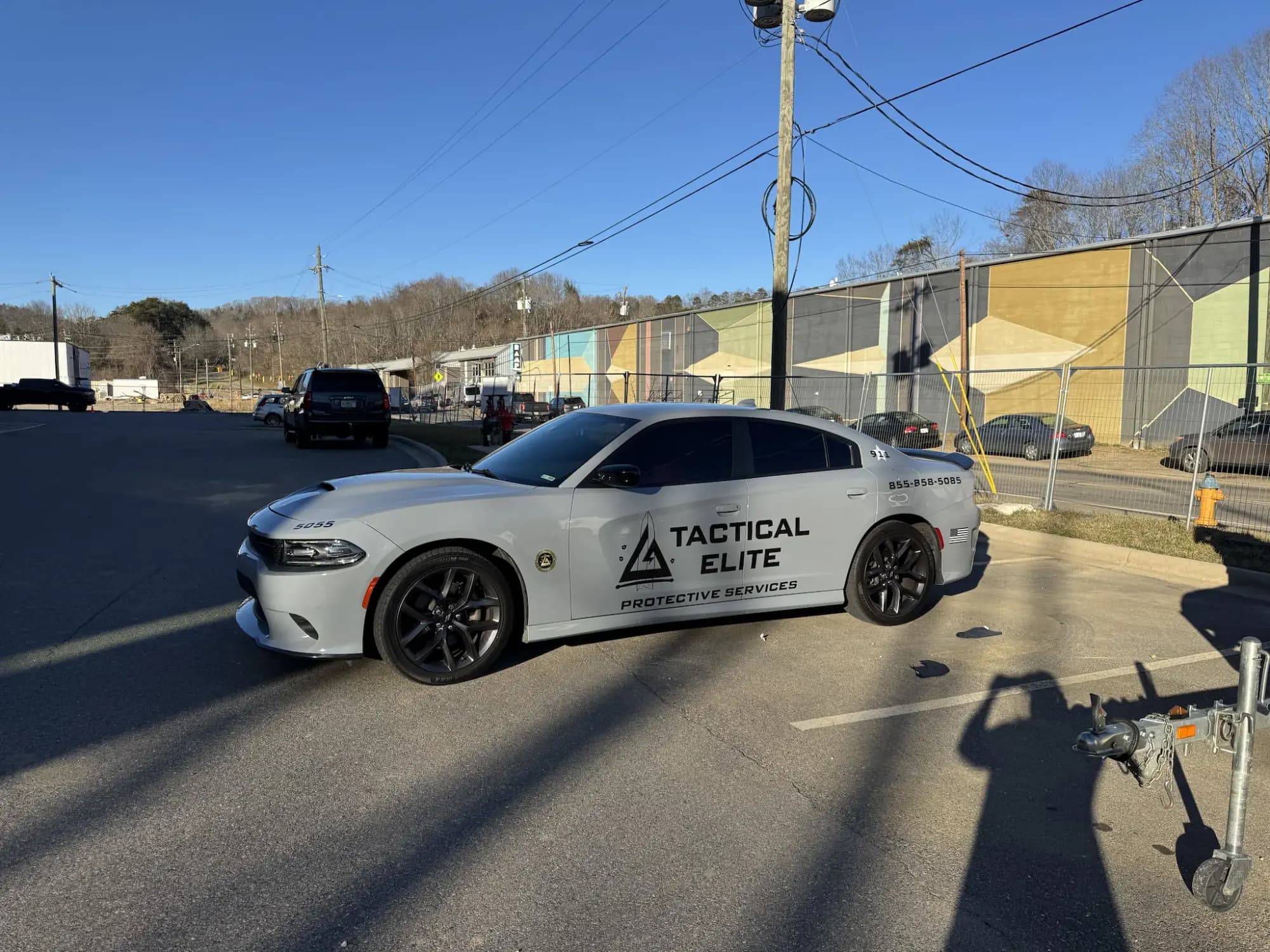 Tactical Elite patrol car parked in front of a commercial site on a clear day